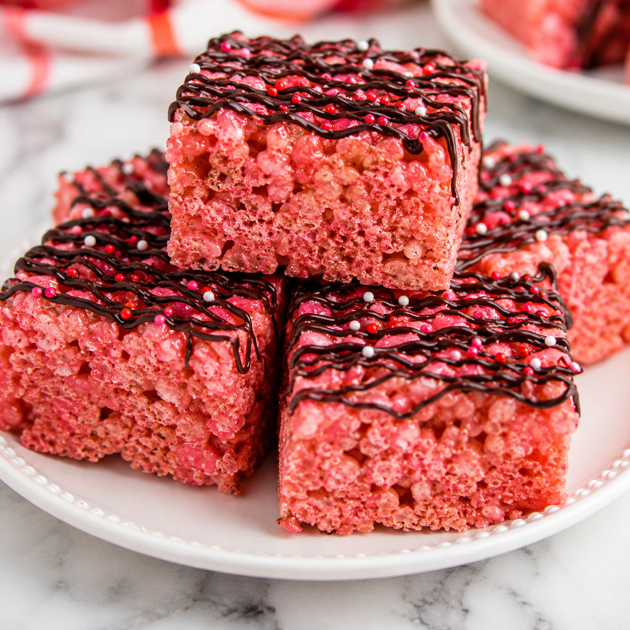 Cherry Rice Krispie treat squares with dark chocolate drizzle