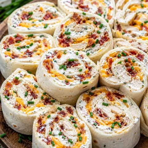 Platter of chicken bacon ranch tortilla pinwheels with chive garnish