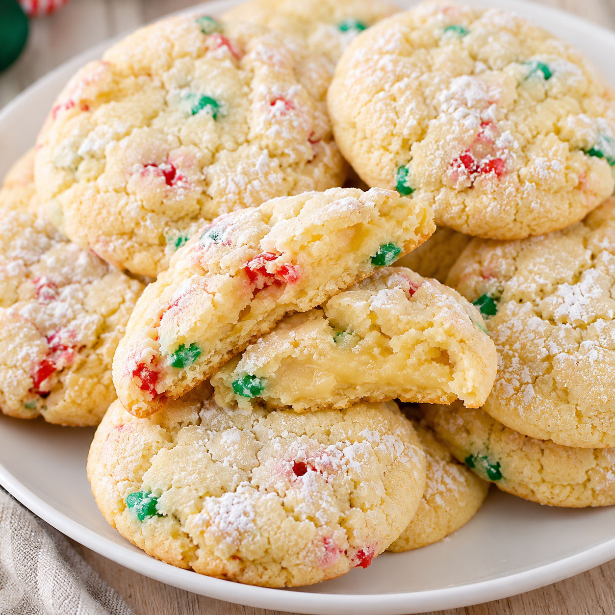 Christmas gooey butter cookies with powdered sugar and red green sprinkles