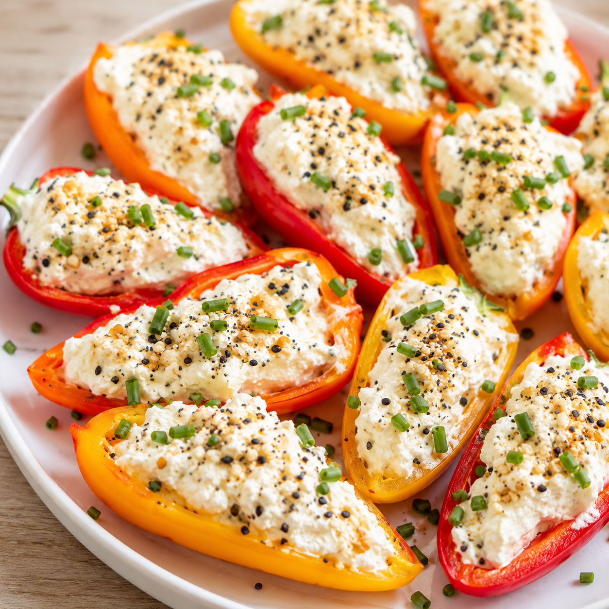 Cream cheese stuffed mini sweet peppers with everything bagel seasoning and chives