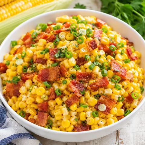 Fresh corn and bacon side dish with scallions and parsley
