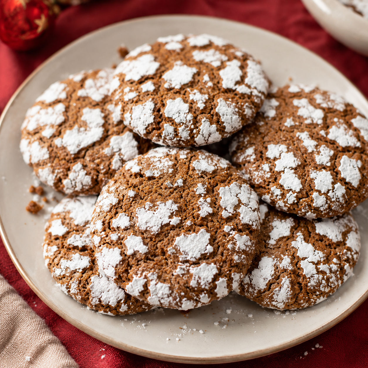 Gingerbread crinkle cookies with snowy sugar cracks on a plate