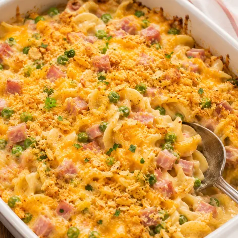 Creamy ham and noodle casserole with peas, cheddar, and golden crumbs