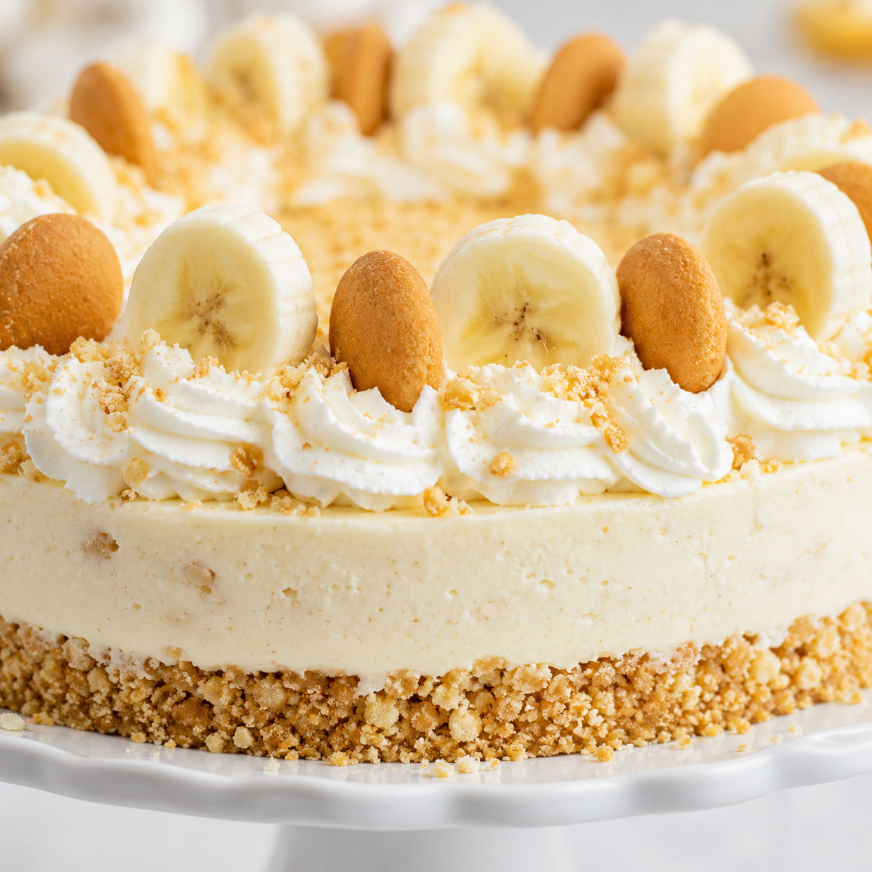 Banana pudding cheesecake with whipped cream, wafers, and banana slices