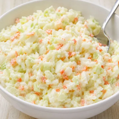 Creamy KFC-style coleslaw with cabbage and carrot in a white bowl