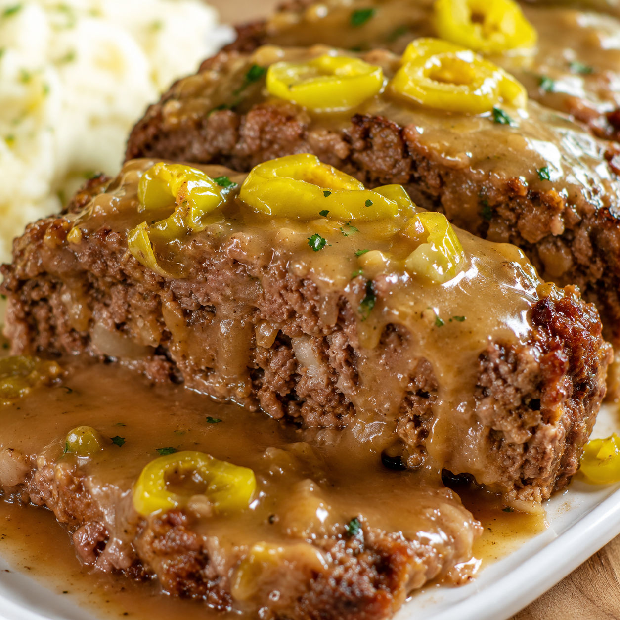 Mississippi meatloaf slices with pepperoncini and buttery gravy