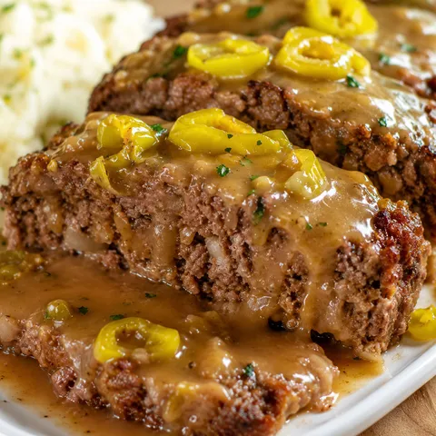 Mississippi meatloaf slices with pepperoncini and buttery gravy