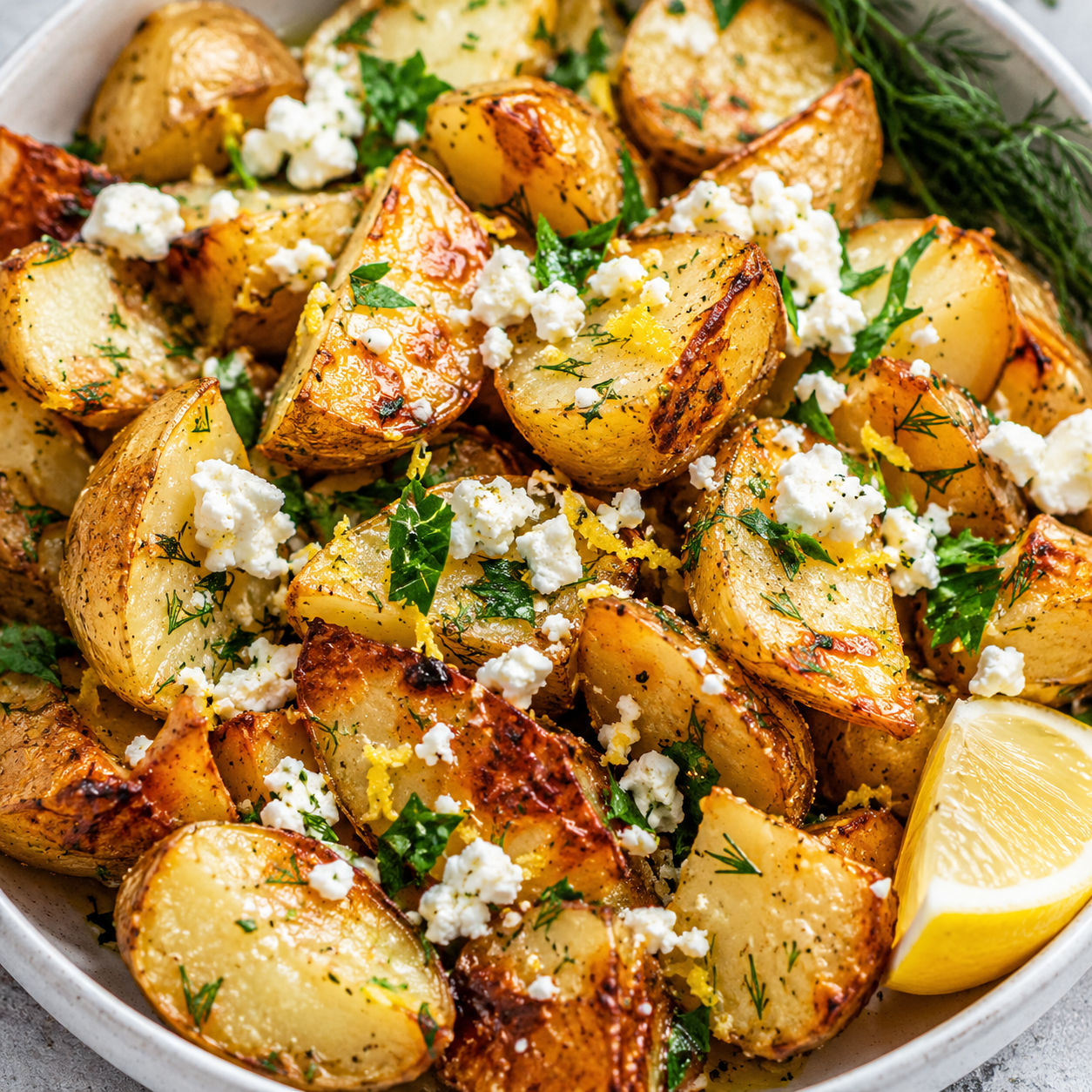 Greek roast potatoes with lemon, feta, herbs, and golden edges