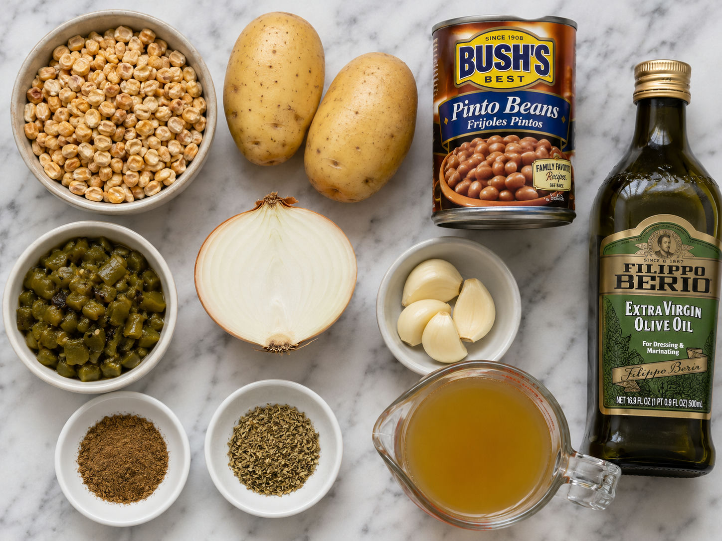 Raw ingredients for green chile papas and beans with chicos on a wooden surface