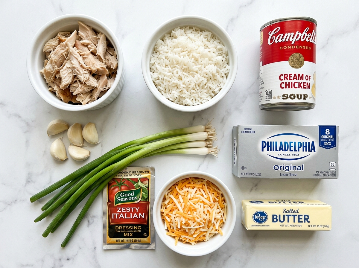 Raw ingredients for creamy chicken rice casserole on a wooden counter