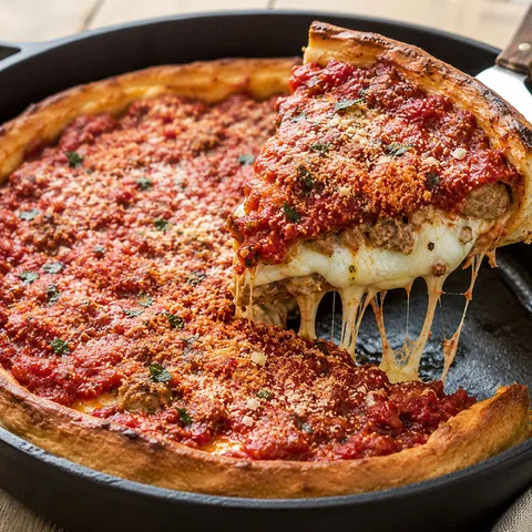 Chicago style deep dish pizza with tomato sauce, sausage, and melted cheese