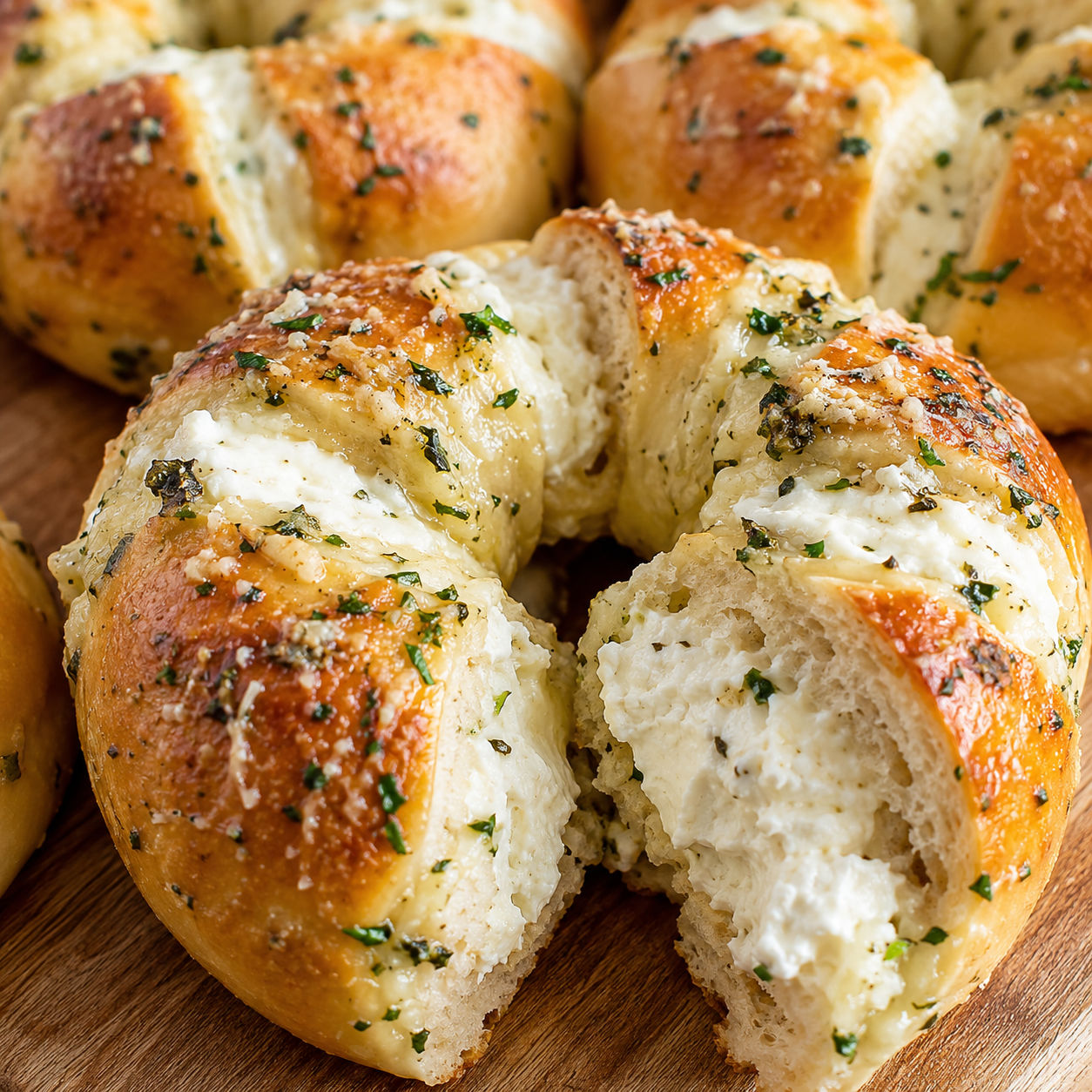 Cream cheese stuffed garlic bagels with parsley butter and parmesan