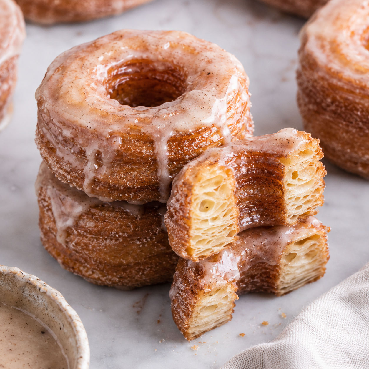 Glazed Homemade Cronuts with flaky golden layers and cinnamon sugar