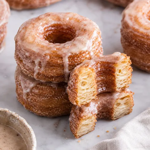 Glazed Homemade Cronuts with flaky golden layers and cinnamon sugar