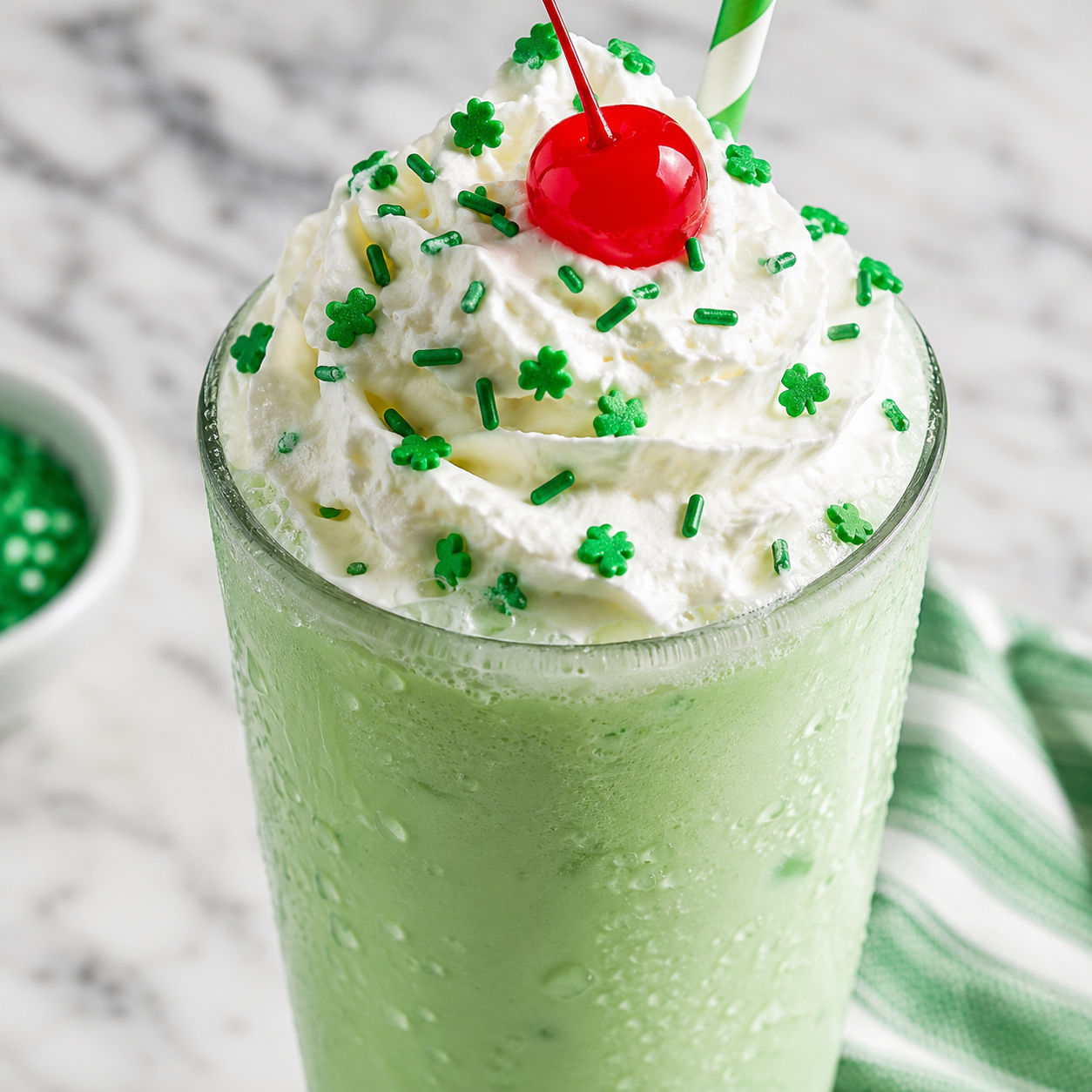 Homemade Shamrock Shake with whipped cream, sprinkles, and a cherry
