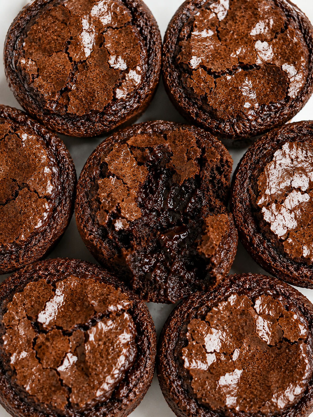 Overhead cluster of muffin pan brownies with crispy edges and chewy fudgy centers
