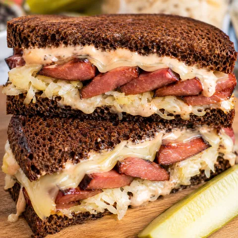 Kielbasa Reuben sandwich with sauerkraut, Swiss cheese, and rye bread