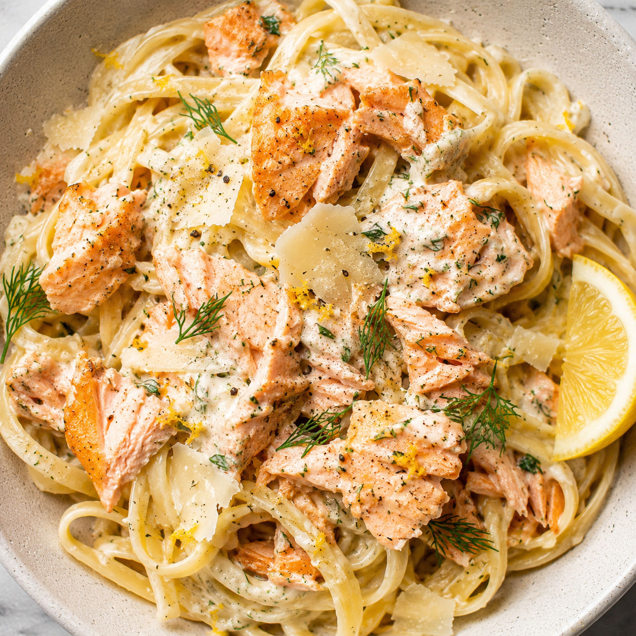Lemon dill salmon with creamy linguine, fresh dill, and lemon zest