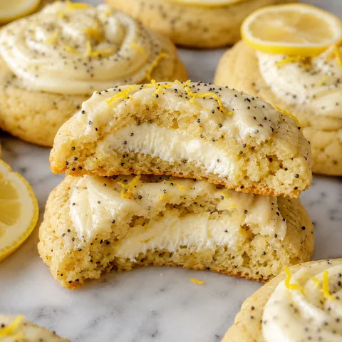 Lemon poppy seed cookies with creamy cheesecake filling and lemon frosting