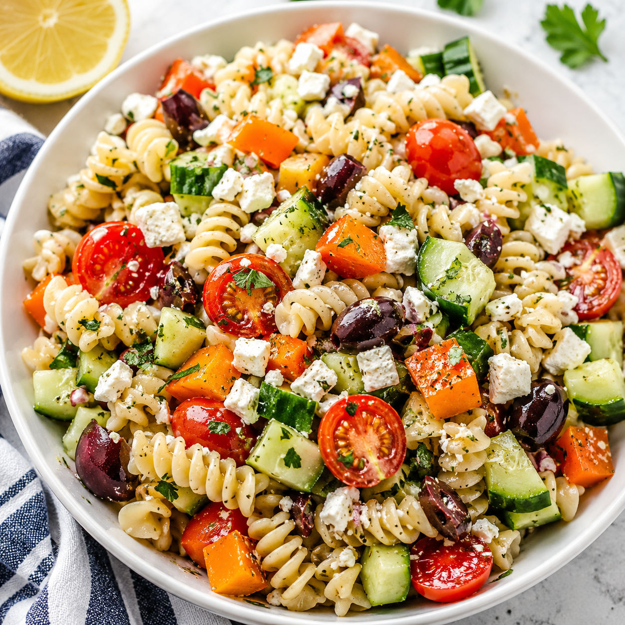 Greek pasta salad with feta, olives, cucumber, tomatoes, and rotini