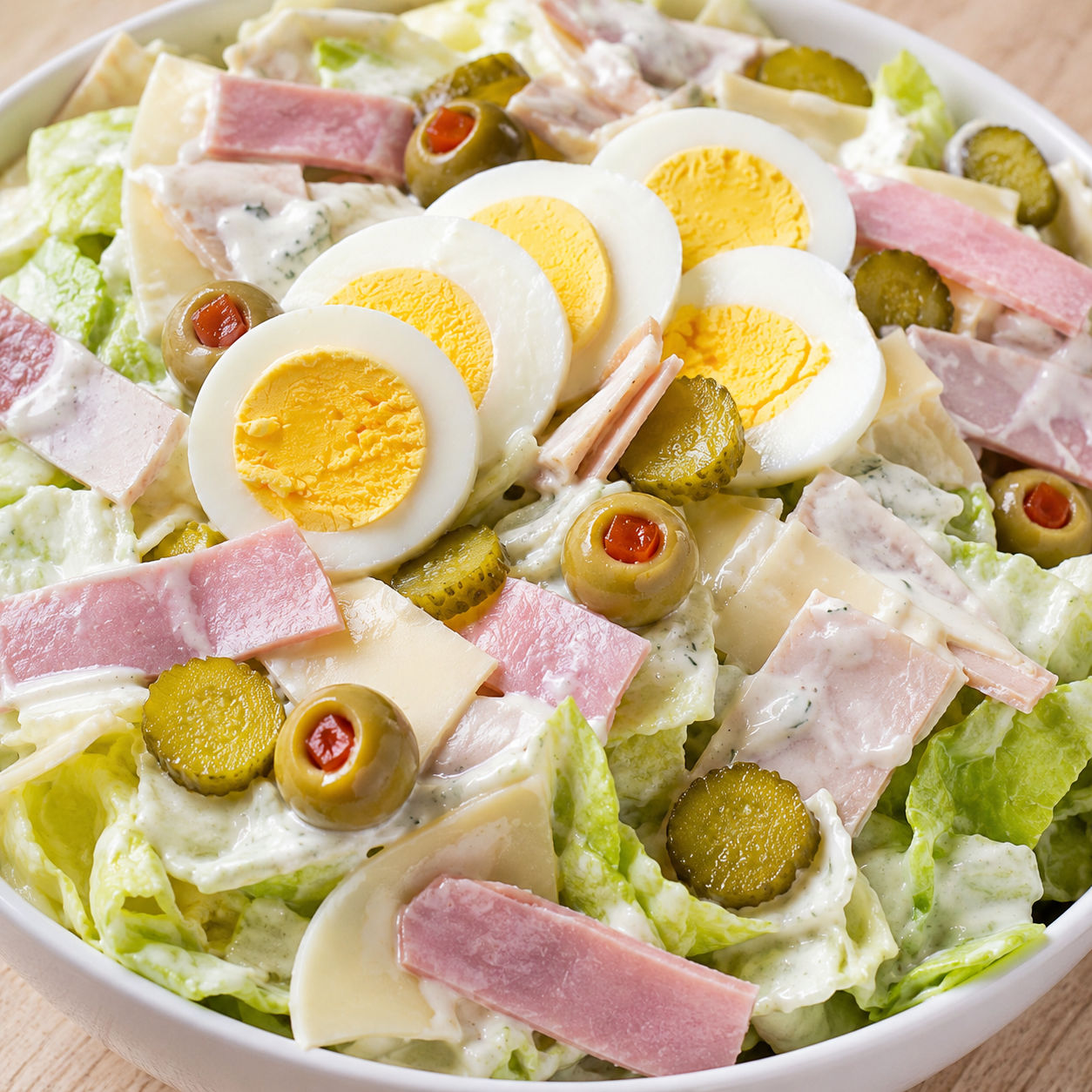 Maurice salad with ham, turkey, Swiss, pickles, olives, and creamy dressing