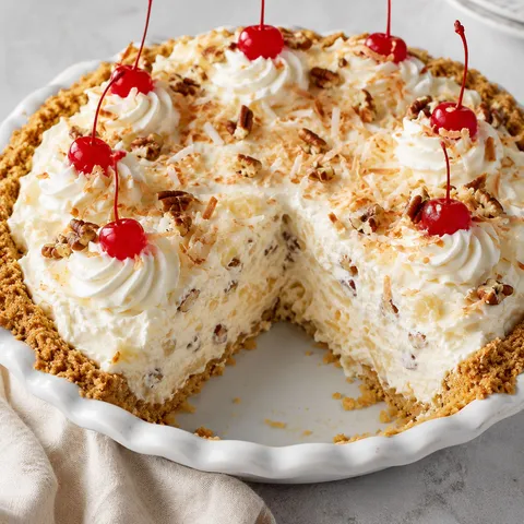 Million Dollar Pie with cherries, coconut, pecans, and a creamy slice