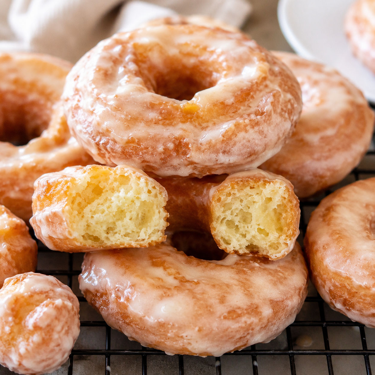 Glazed old-fashioned sour cream doughnuts with craggy golden ridges