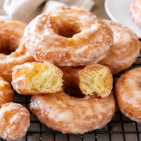 Glazed old-fashioned sour cream doughnuts with craggy golden ridges