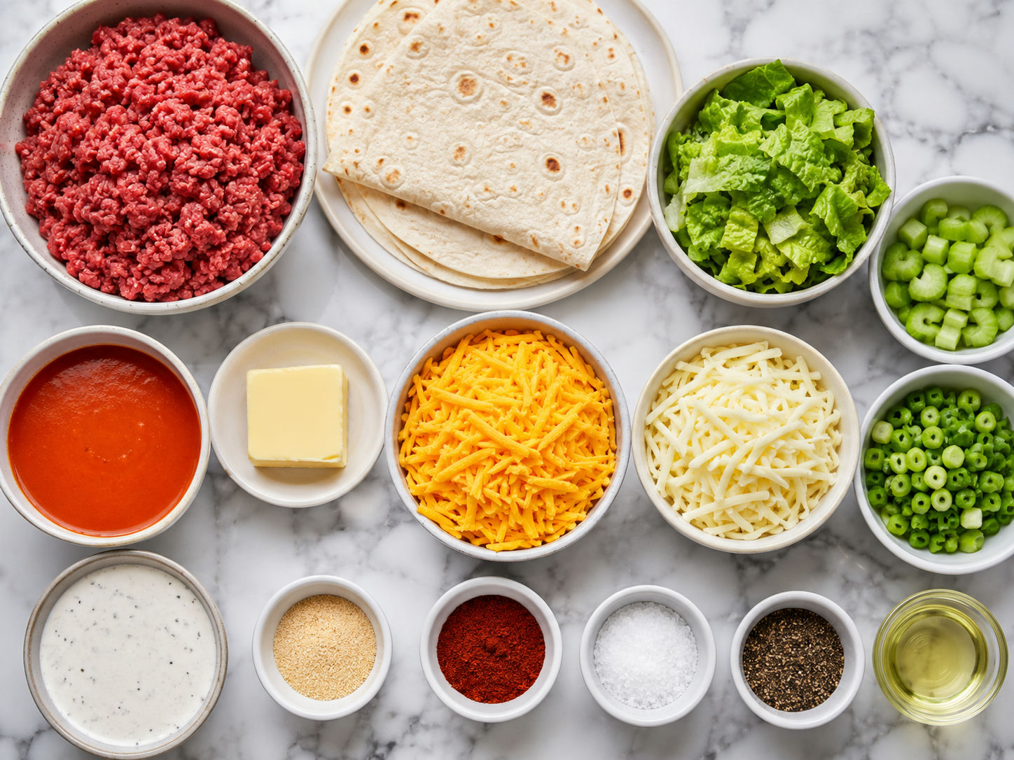 Ingredients for buffalo beef wraps with tortillas, beef, cheese, lettuce, and sauce