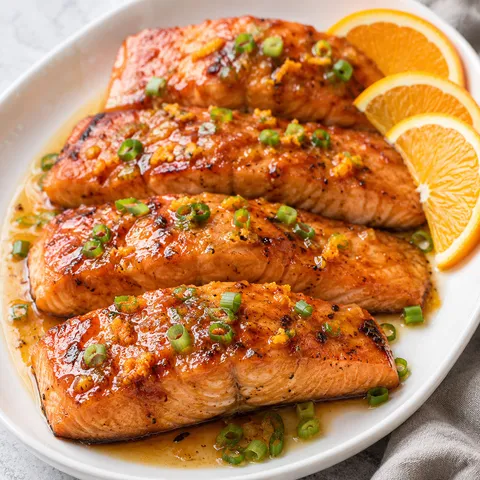 Pan-fried orange salmon with glossy citrus glaze and scallions