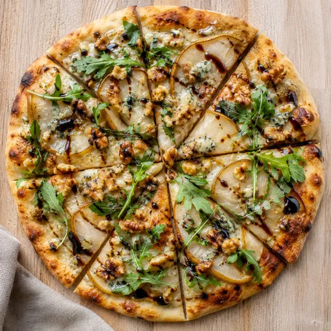 Pear Gorgonzola flatbread with walnut crumble, arugula, and balsamic glaze