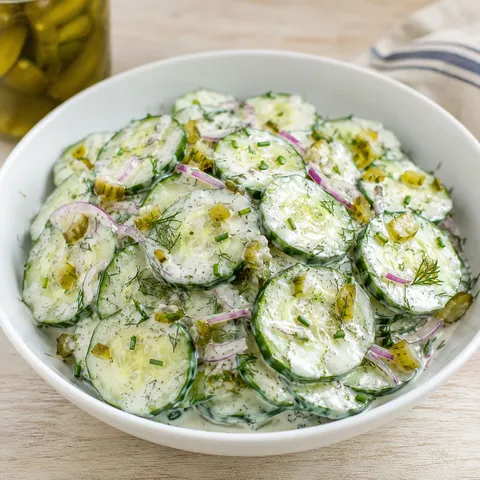 Creamy pickle juice cucumber salad with dill, chives, and red onion