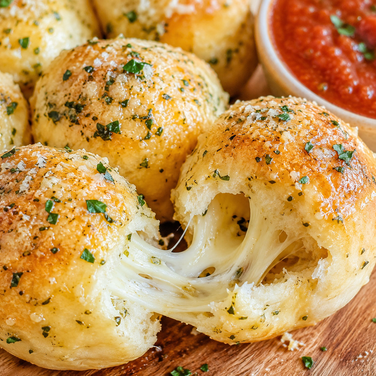 Garlic butter cheese biscuit bombs with melted mozzarella and parsley