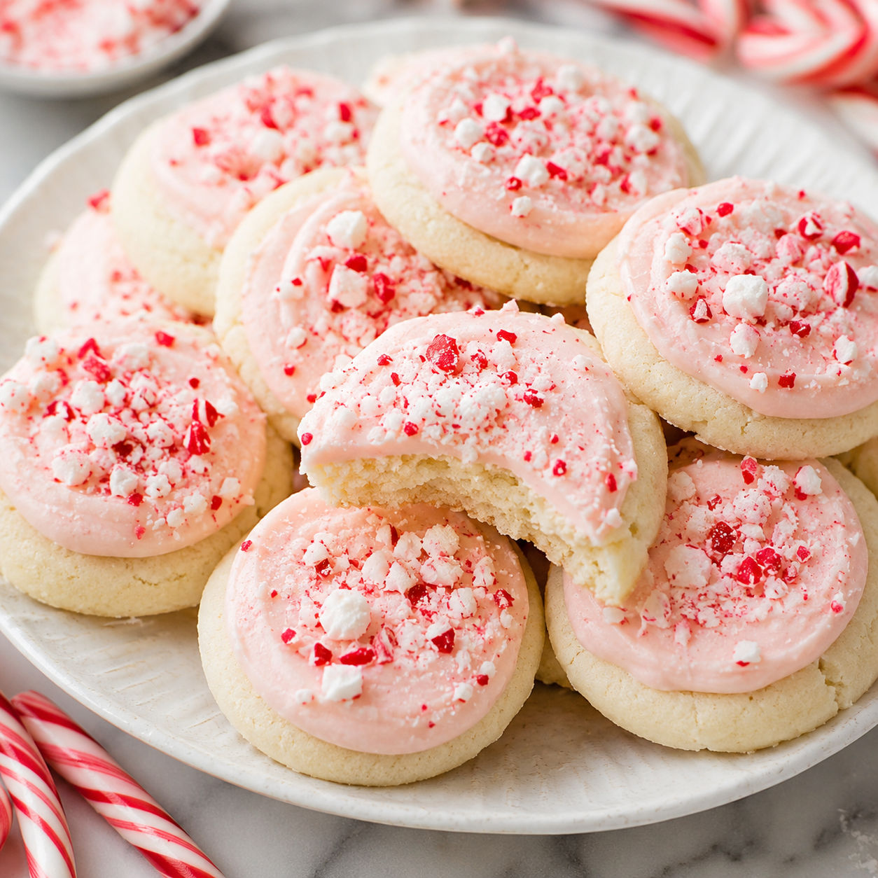 Peppermint meltaway cookies with pink frosting and crushed candy cane