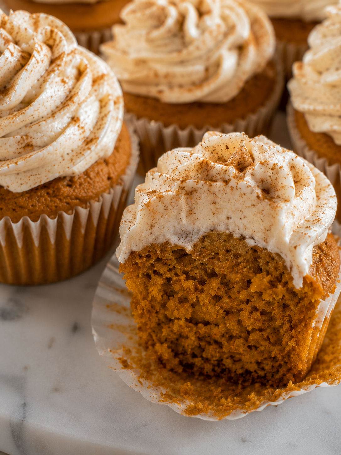 Pumpkin Spice Cupcakes with Cinnamon Cream Cheese Frosting, plated and served