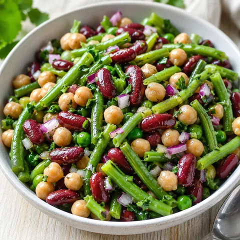 Three bean salad with green beans, kidney beans, chickpeas, and parsley