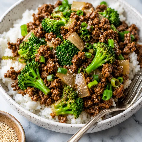 Ground beef and broccoli stir fry with rice, scallions, and sesame seeds