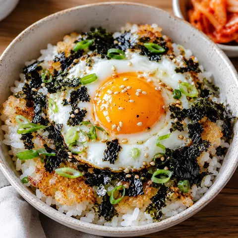 Korean egg rice with sunny egg, seaweed, sesame seeds, and scallions