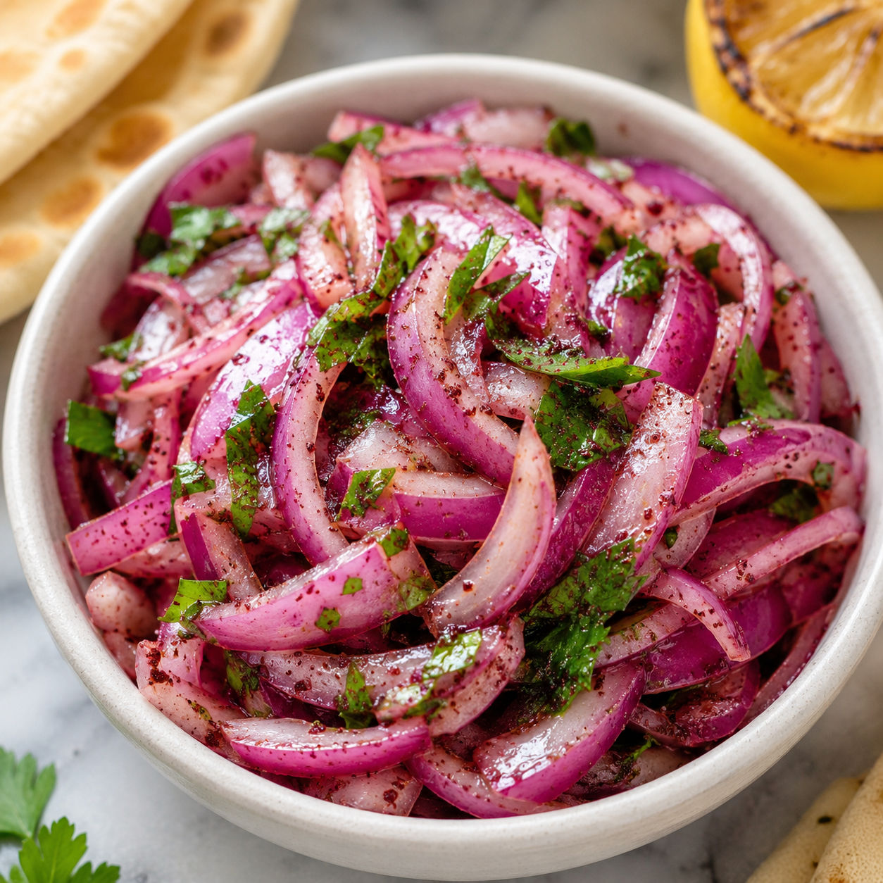 Quick Sumac Onions with parsley in a white ceramic bowl