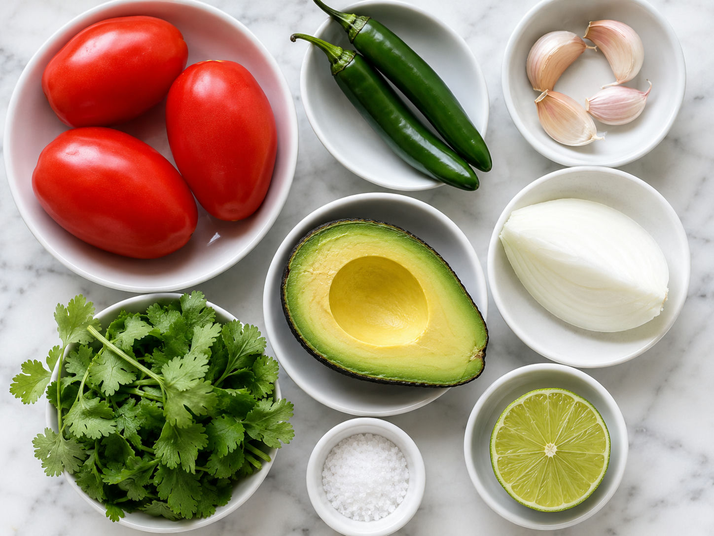 Raw ingredients for salsa de molcajete con aguacate on a wooden surface