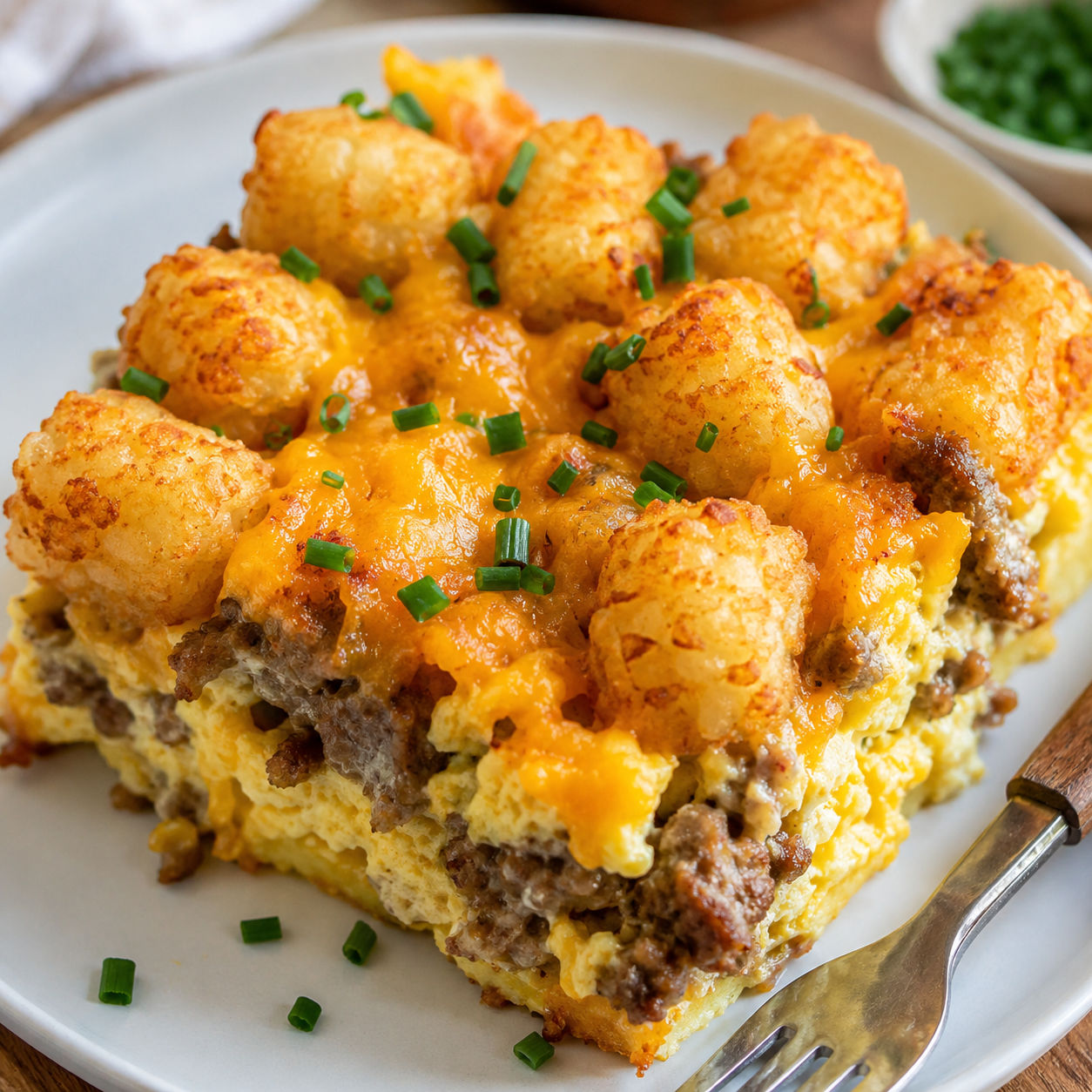 Sausage tater tot breakfast casserole with cheddar and chives