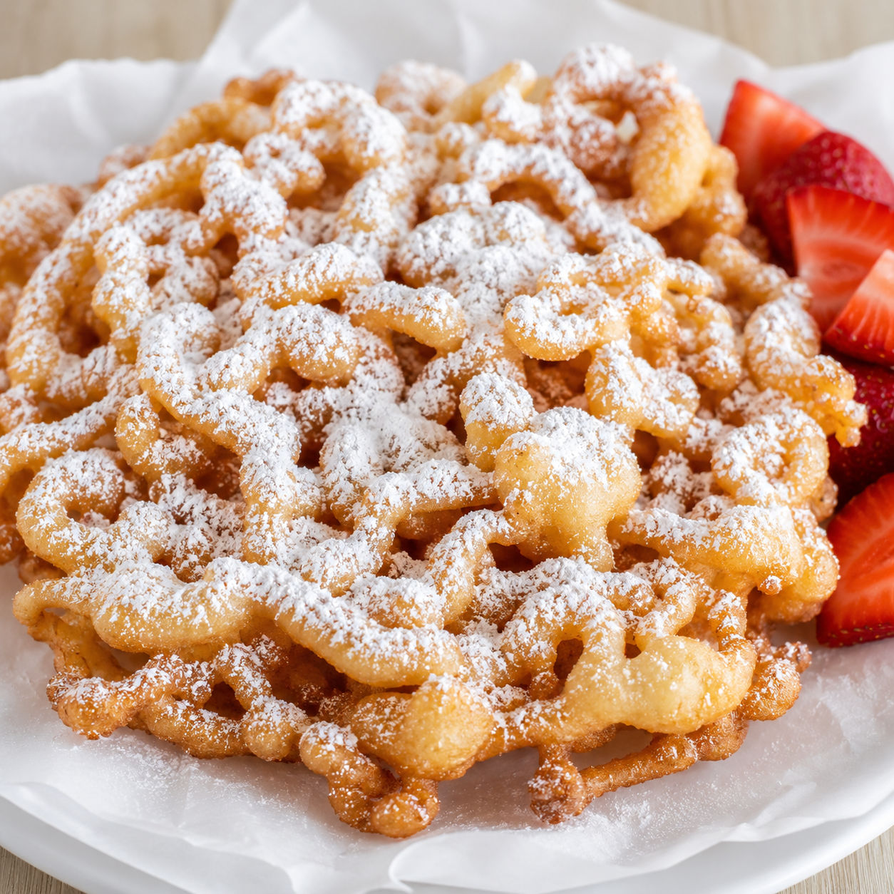 County fair funnel cake with powdered sugar and strawberries