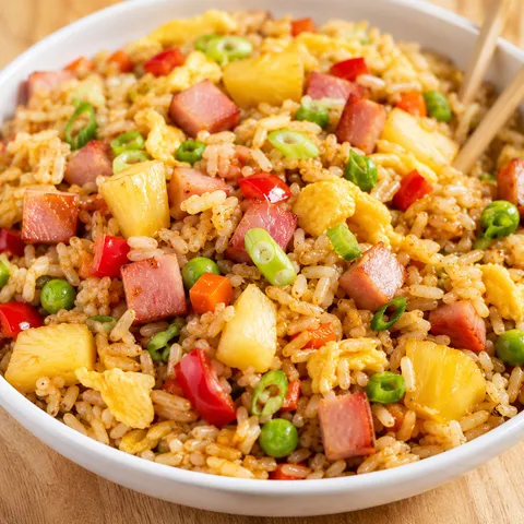 Hawaiian fried rice with pineapple, ham, egg, peas, and green onions
