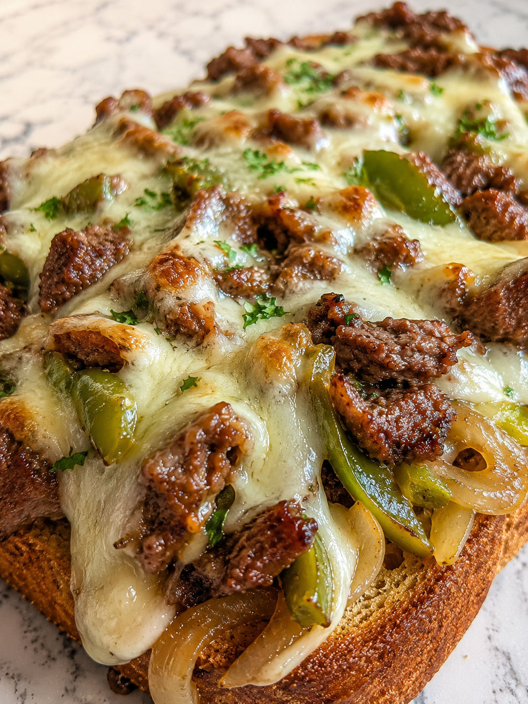 Savor The Unforgettable Steak And Cheese Garlic Toast, plated and served