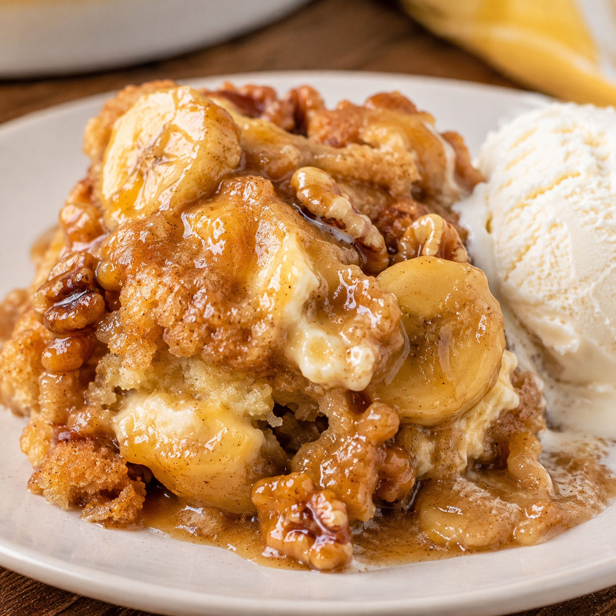 Warm bananas foster cobbler with walnuts and vanilla ice cream