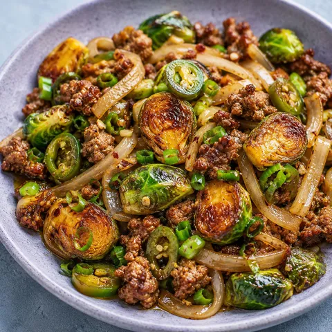 Five-spice Brussels sprouts and sausage stir-fry with scallions