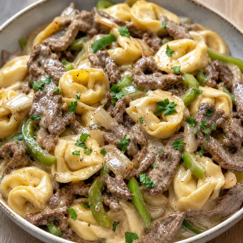 Philly cheesesteak tortellini skillet with beef, peppers, and melted provolone