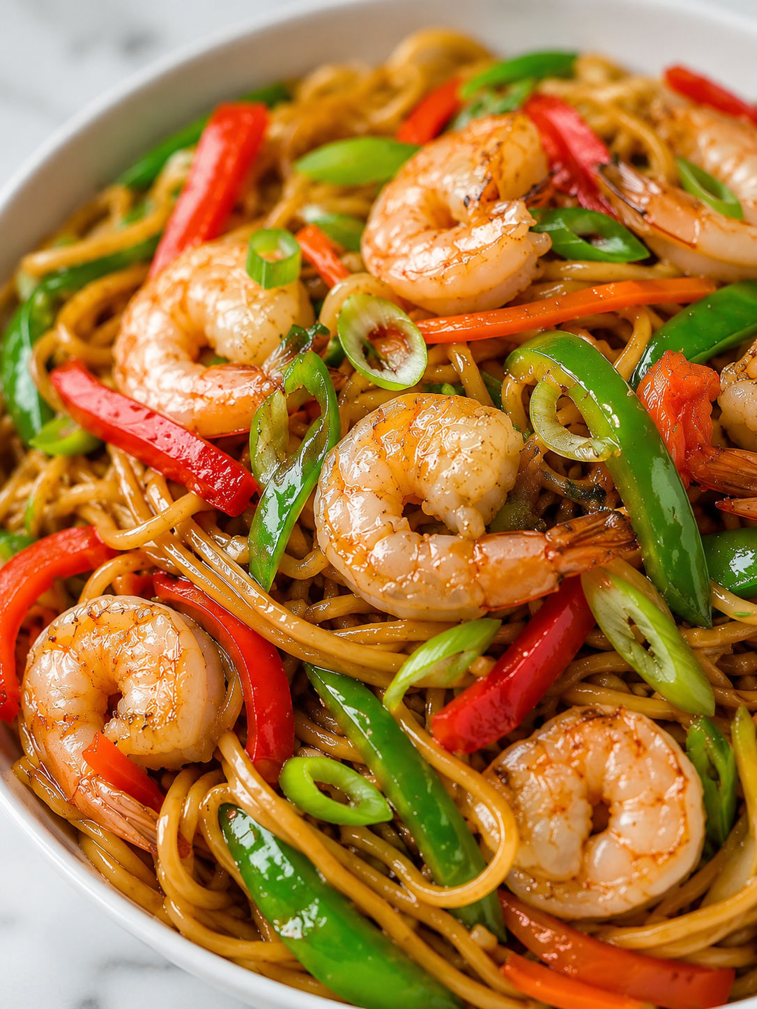 Shrimp Lo Mein With Red And Green Pepper, plated and served