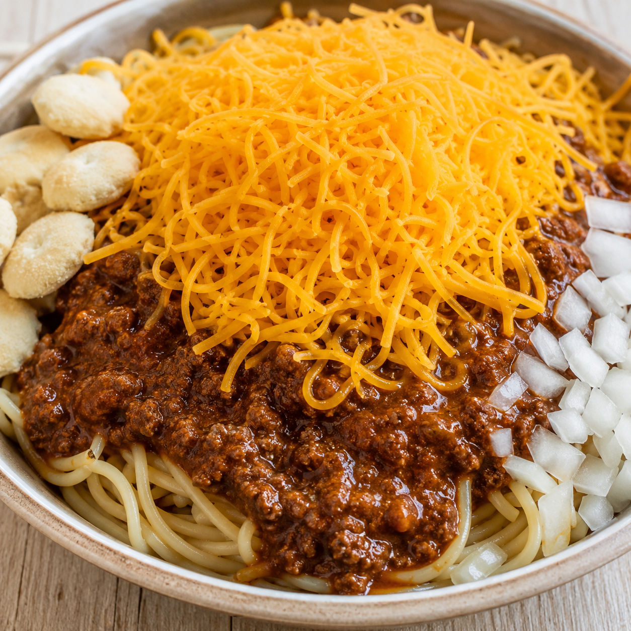 Skyline-style Cincinnati chili over spaghetti with cheddar and onions
