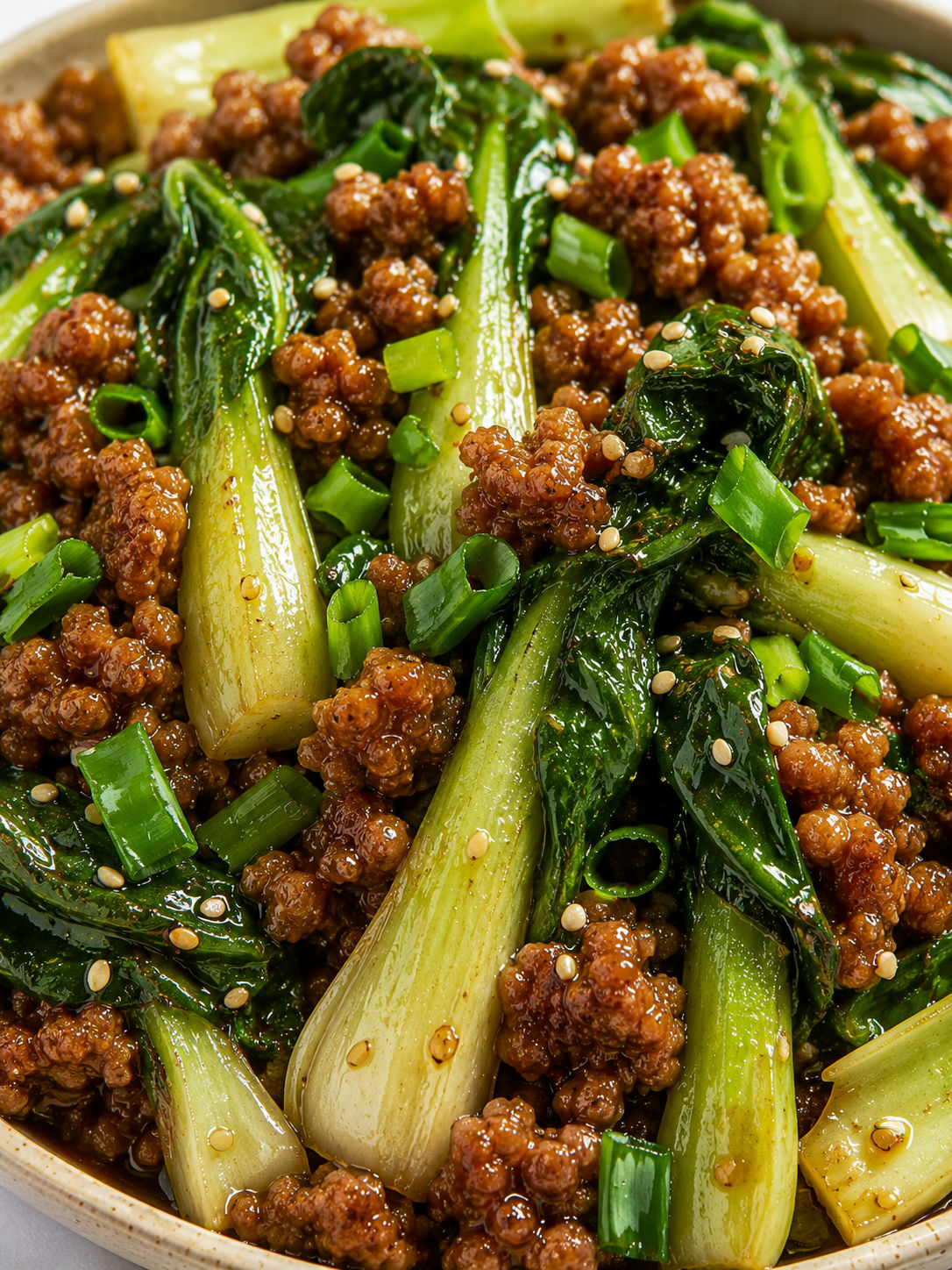 Glossy bok choy and ground meat stir-fry with scallions and sesame seeds